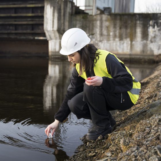 full-shot-environmental-engineer-getting-water-sample